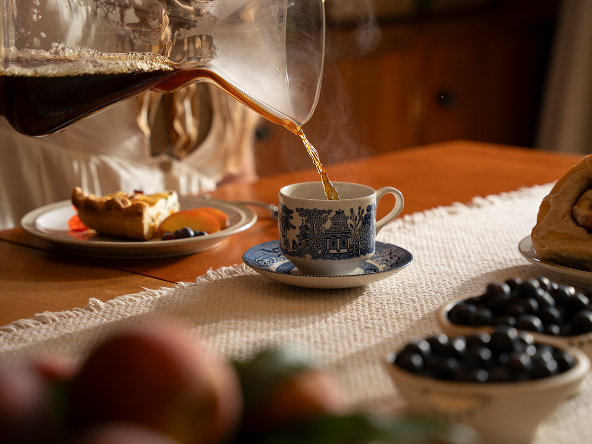 coffee and a slice of pie and some berries